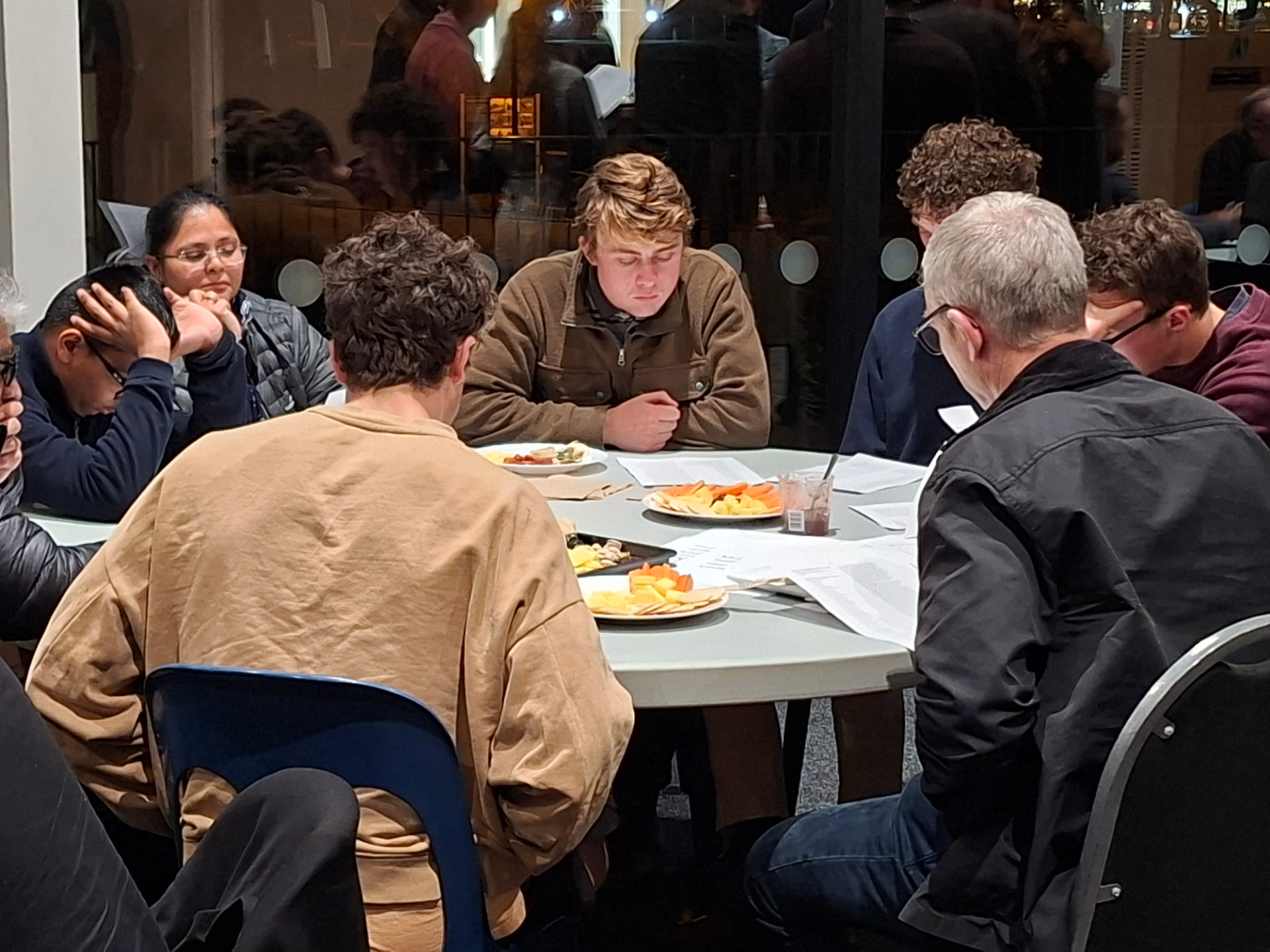 Guests talking through the evening's questions over supper