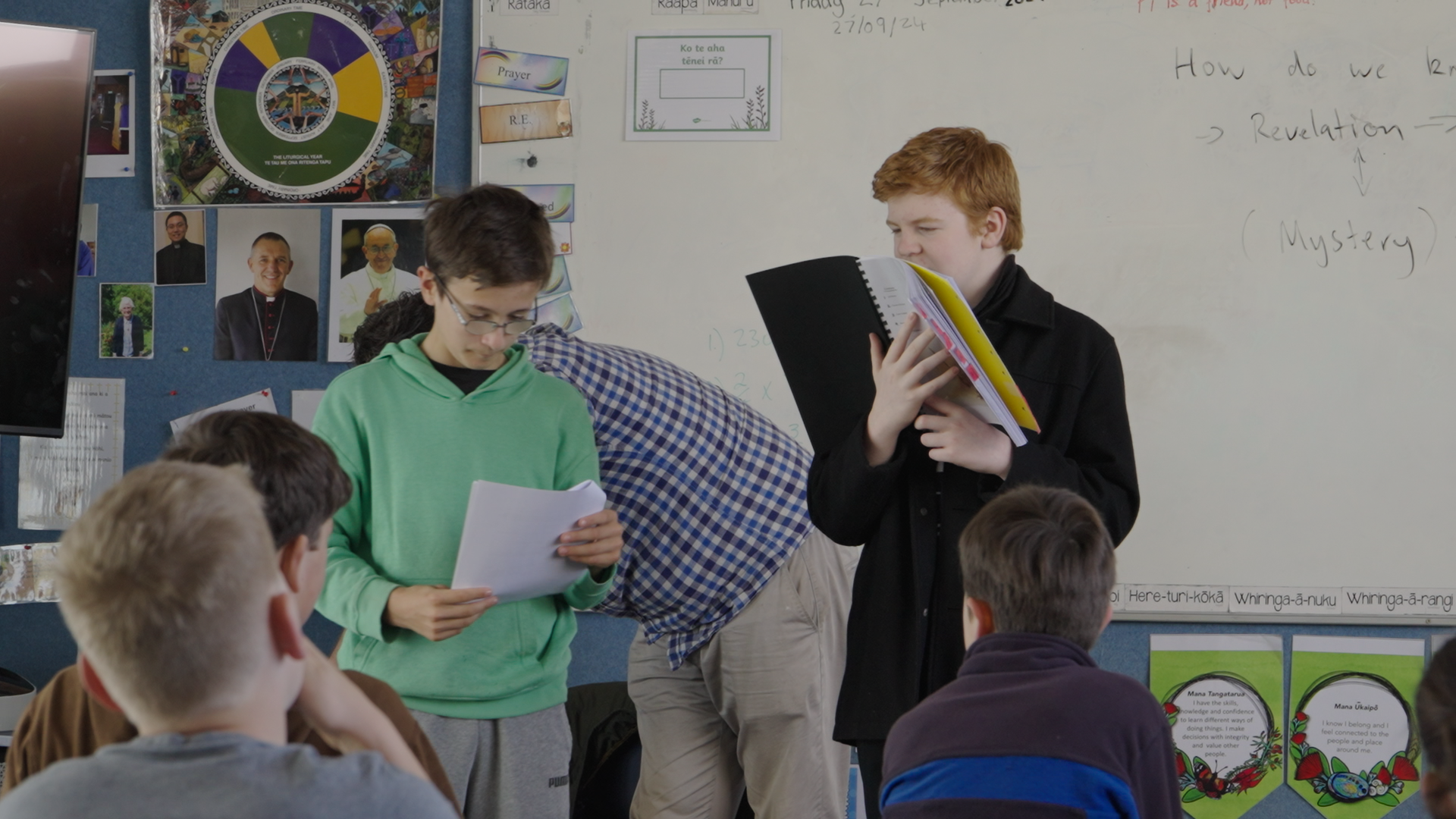 Two students reading aloud to the class at the 2024 Intensive