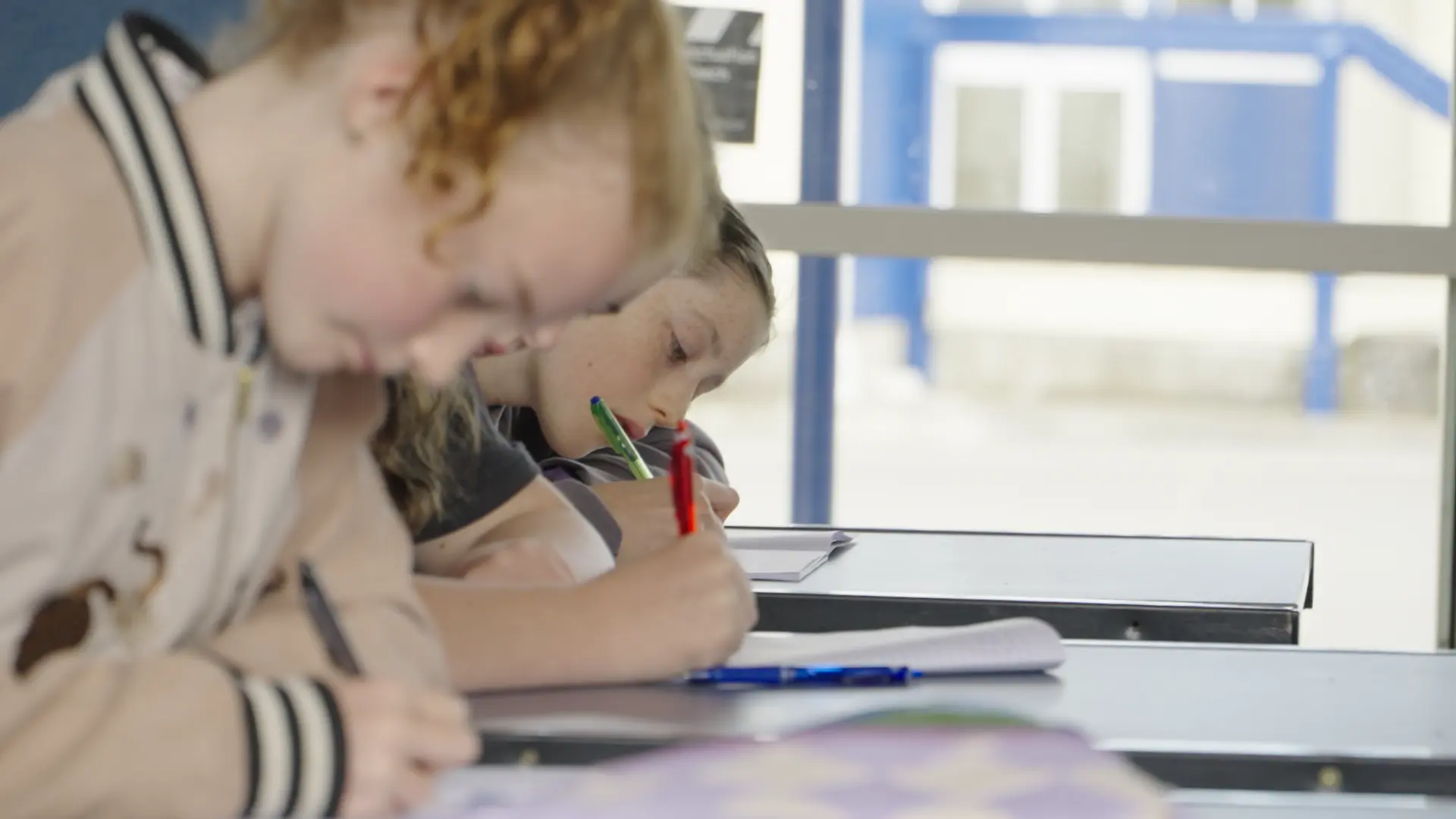 Two junior students writing together at the 2024 Intensive