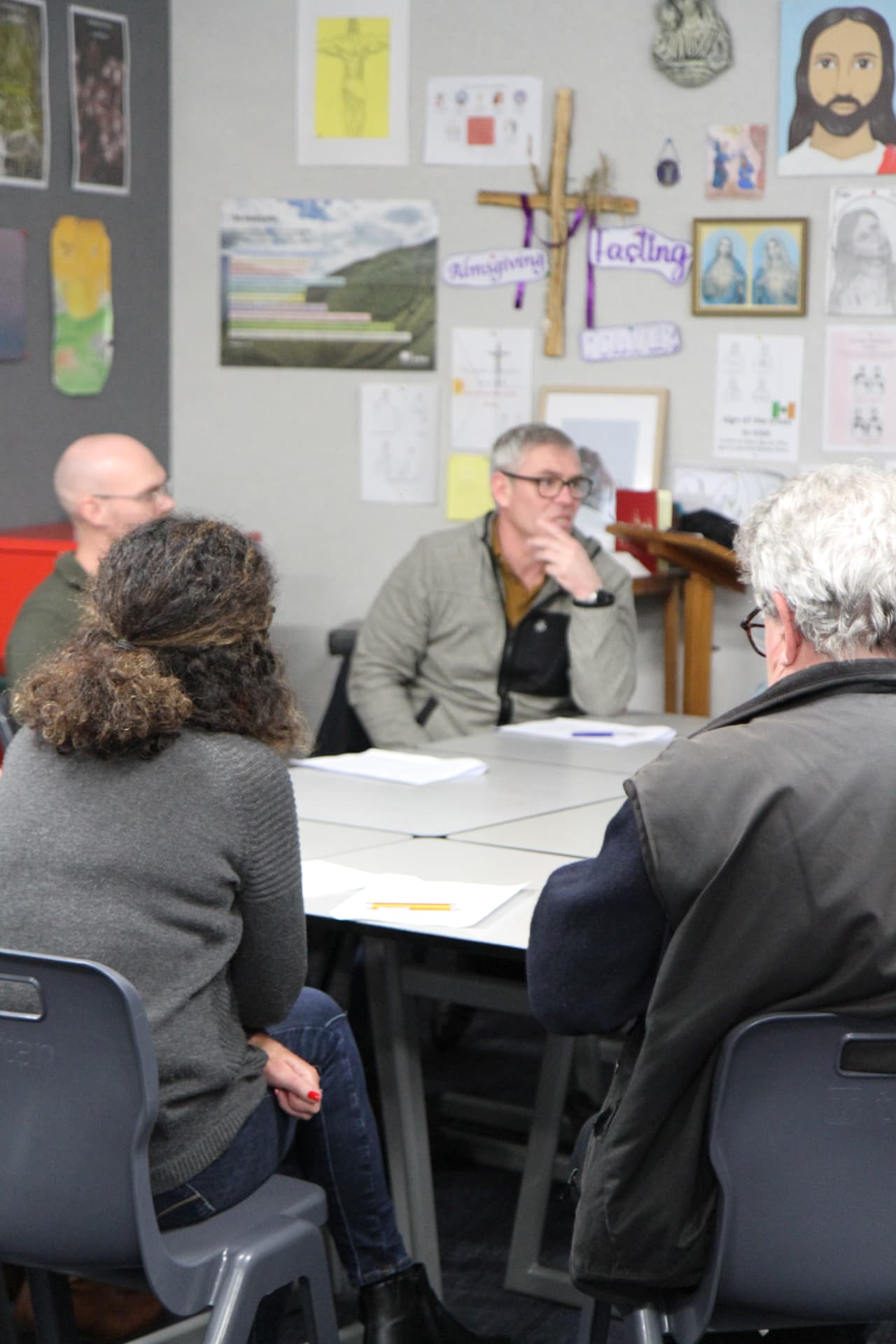 Participants gathered around a table during a course session