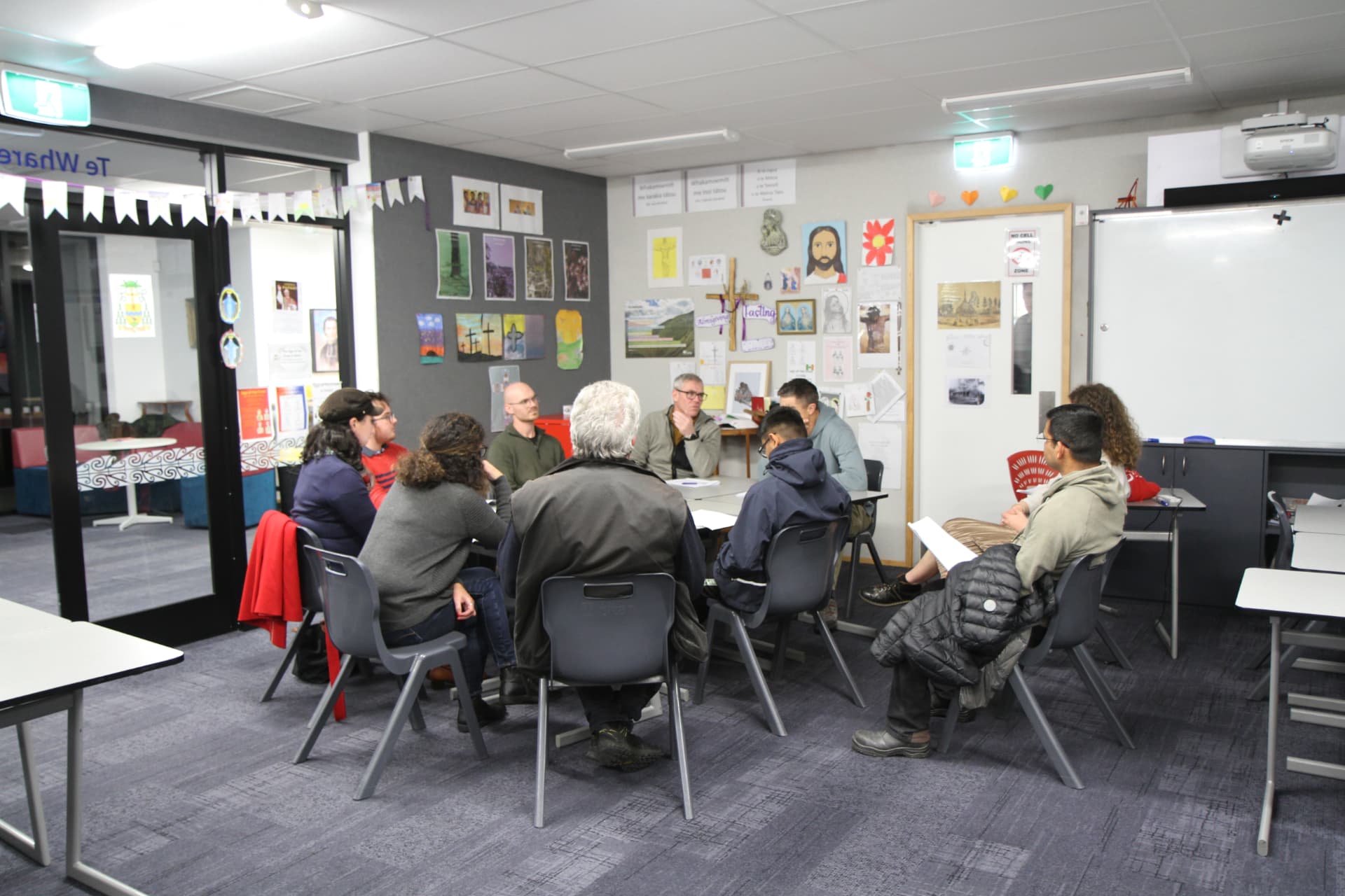 A small group in discussion in the classroom during the course